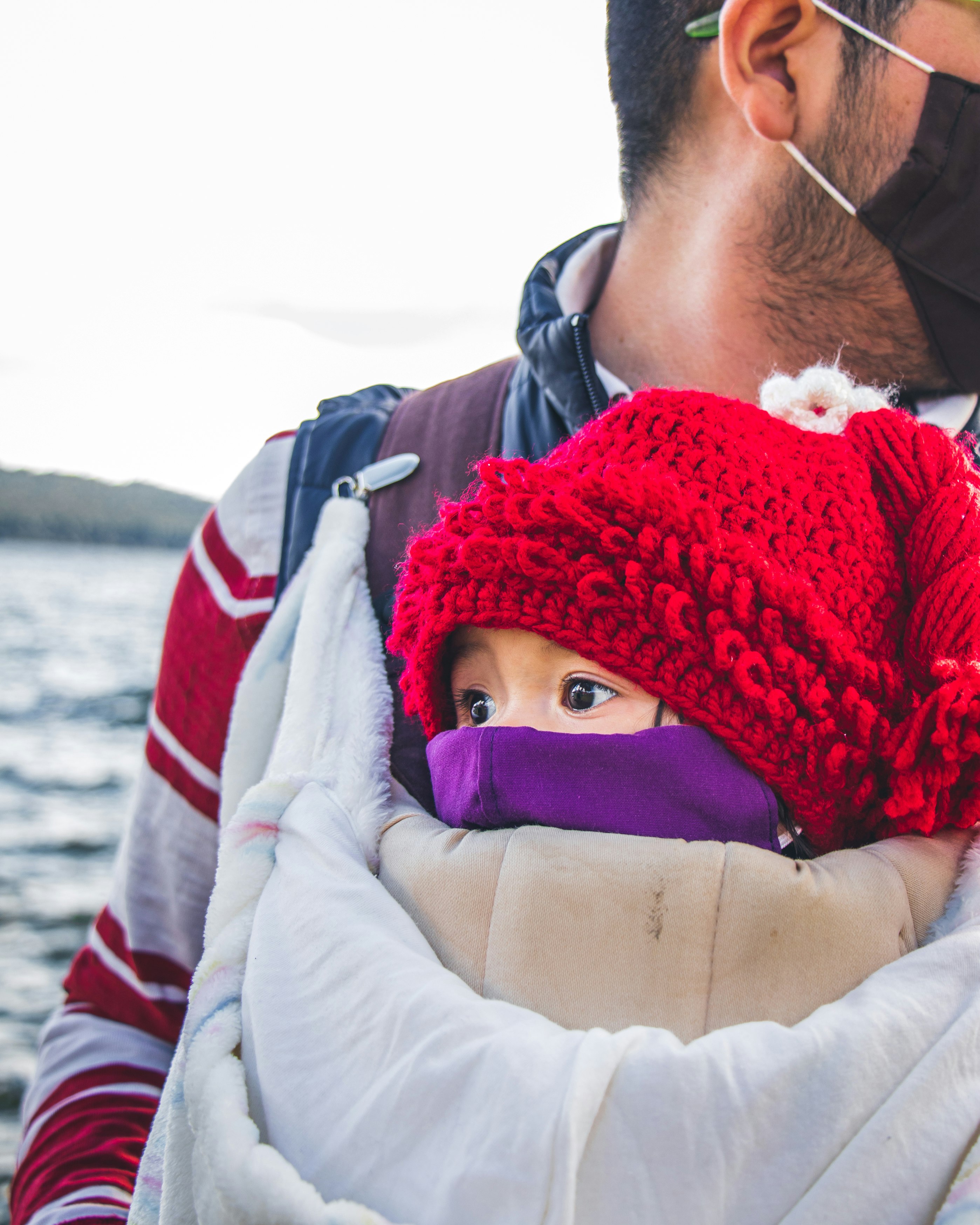 woman in red knit cap and white jacket